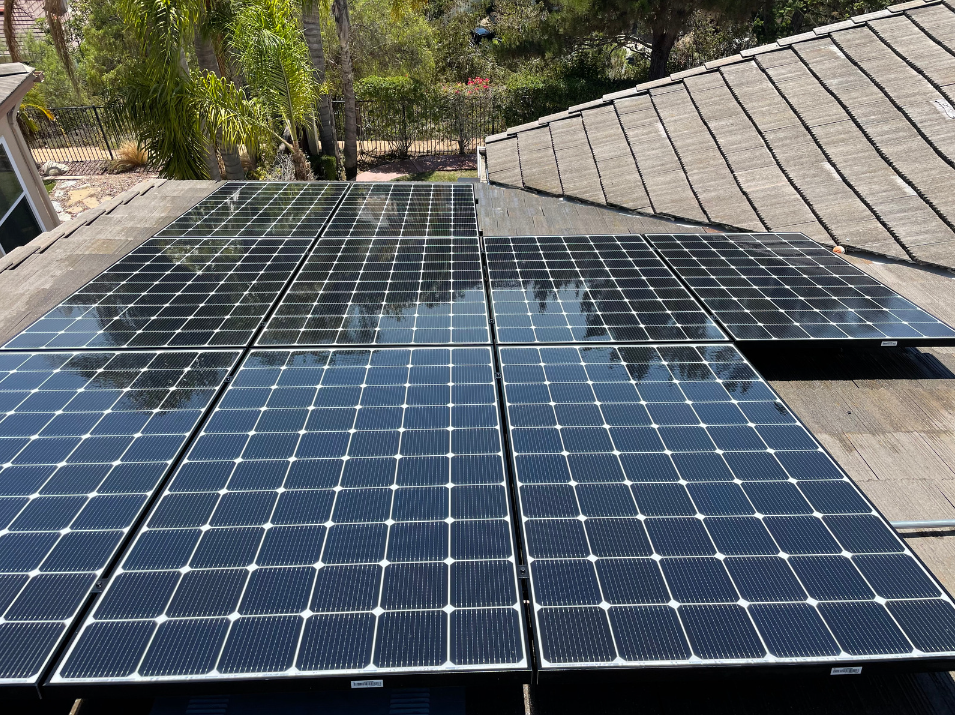 Professionally cleaned solar panels on a two-story tile roof in San Diego, CA